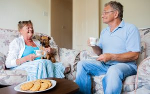 couple relaxing at home with lower energy bills